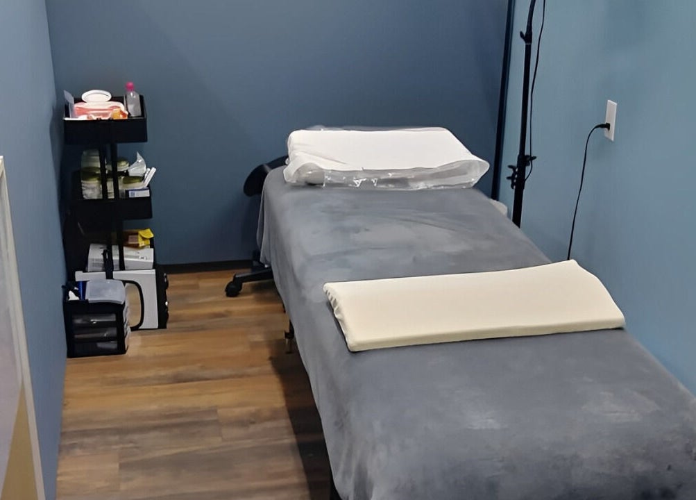 Cozy massage room at Embellished Beauty - Dundalk 52 Main St E, Dundalk, Ontario, CA with a treatment table.