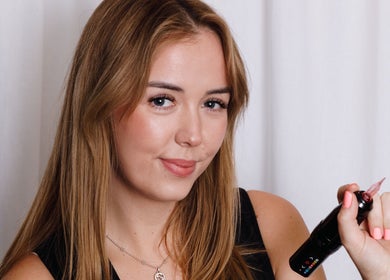 Brookelyn Beauty specialist in Perth, Western Australia, holding a cosmetic tool with flawless skin.