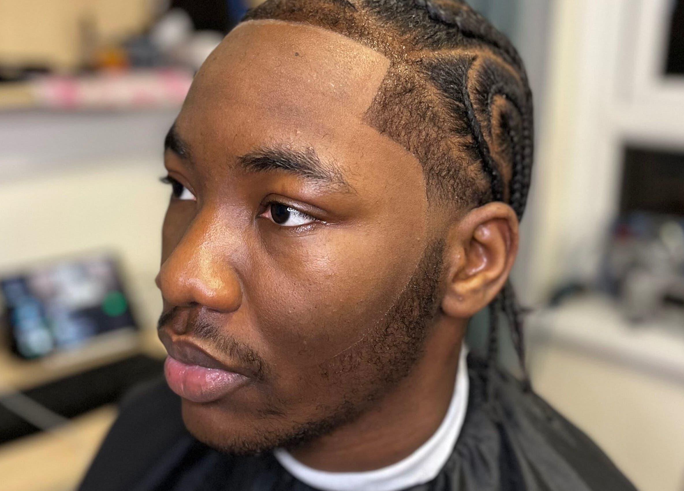Close-up of a man with freshly braided hair at Jujucutthat, Loughborough, England, GB.