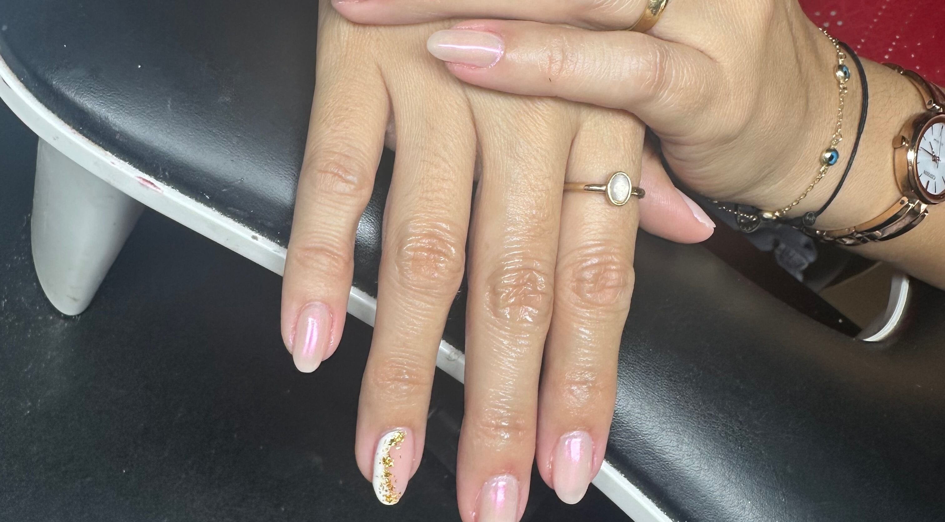 Elegant manicure at Studio777, Cole Bay, Sint Maarten, SX showcasing pink and gold nail art.