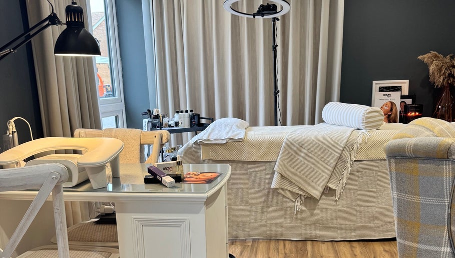 Comfortable treatment room at Brows By Jenna, Northampton, England, GB with a plush bed and calming decor.