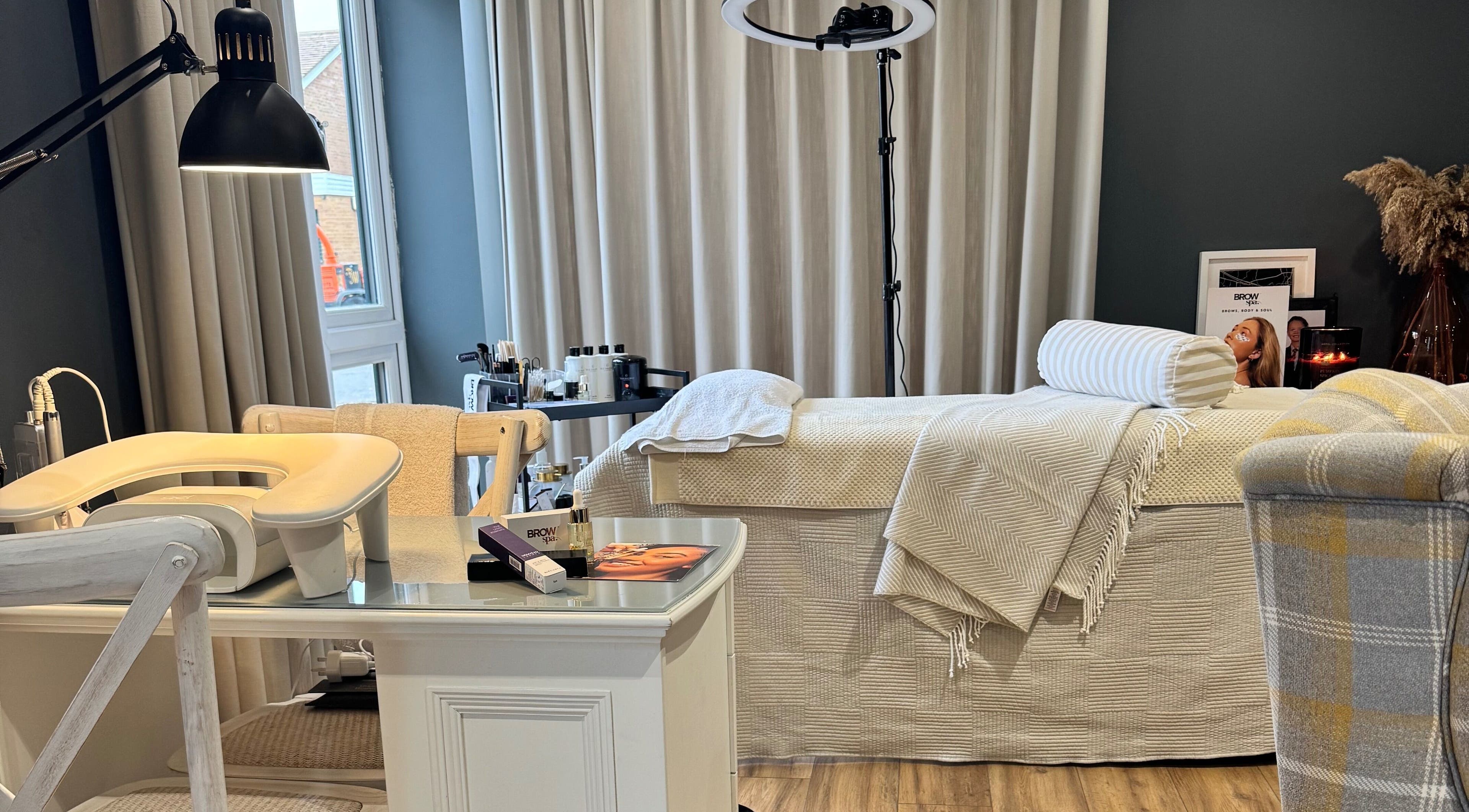 Comfortable treatment room at Brows By Jenna, Northampton, England, GB with a plush bed and calming decor.