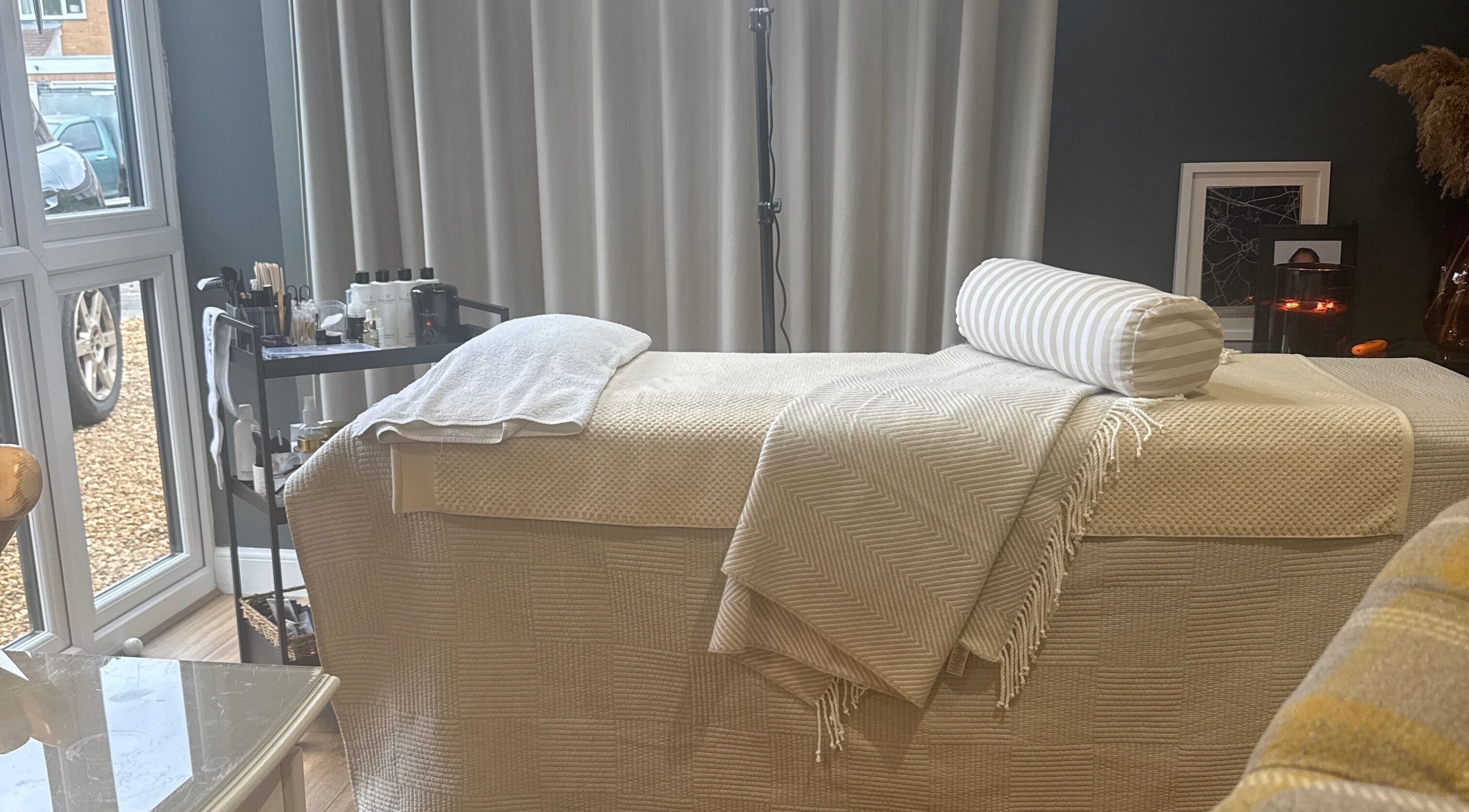 Relaxing treatment room at Brows By Jenna, Northampton, England, GB with cozy massage bed and elegant decor.