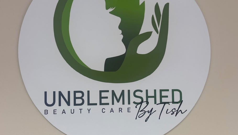 Unblemished By Tish (Anguilla) logo on wall, US location, highlighting beauty care services.
