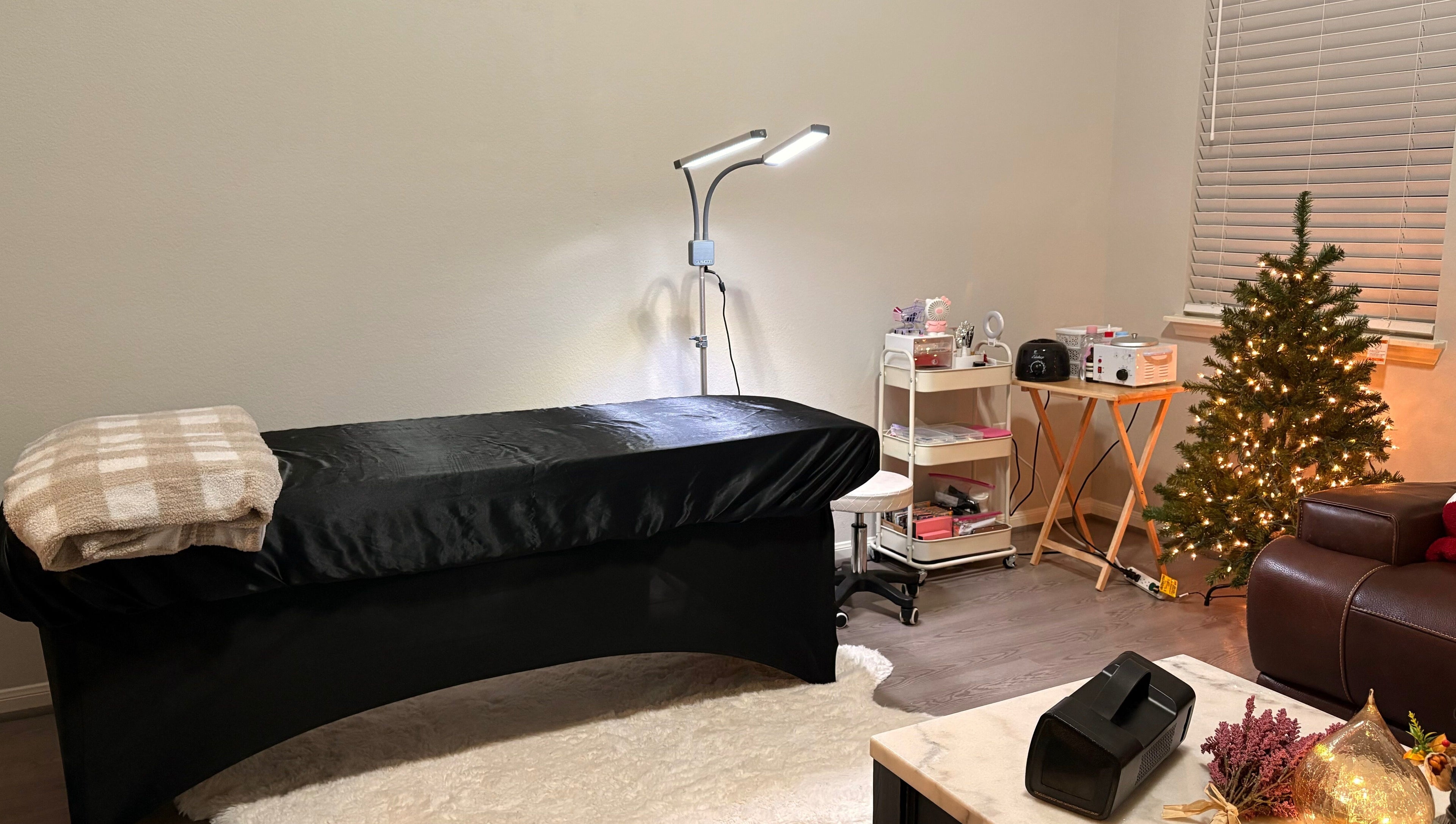 Relaxing spa room at Elegance Studio, Houston, Texas, US, featuring a massage bed and festive decor.