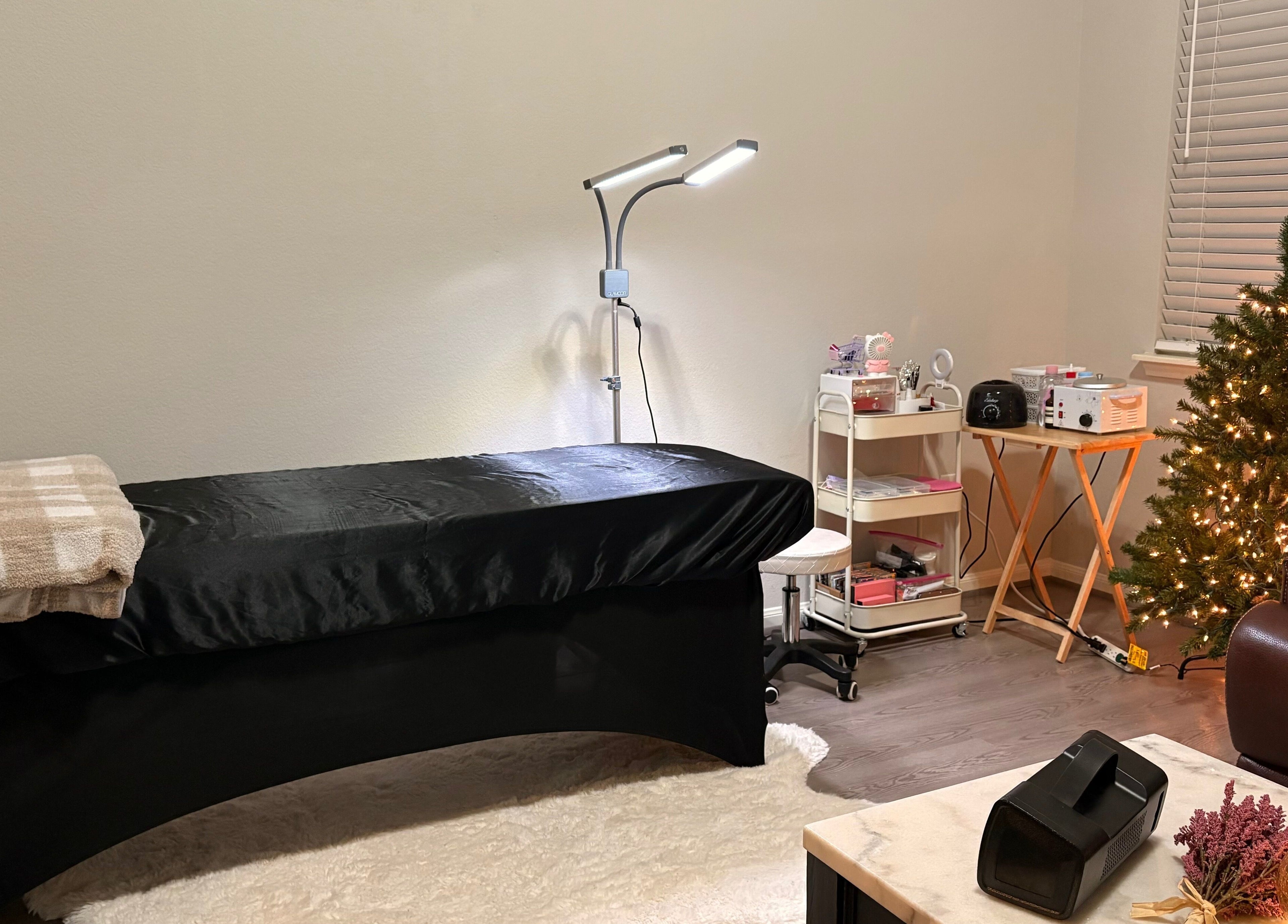 Relaxing spa room at Elegance Studio, Houston, Texas, US, featuring a massage bed and festive decor.
