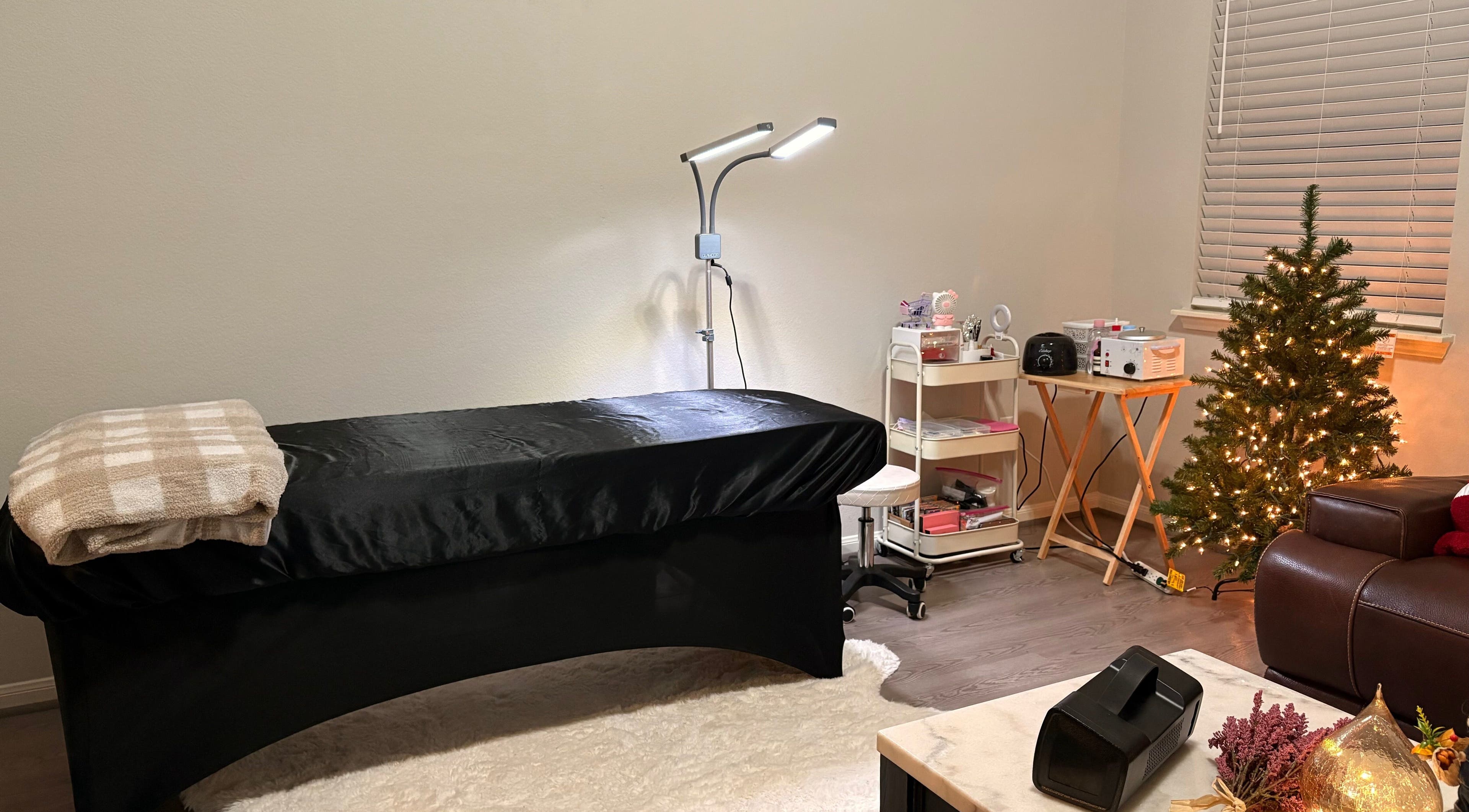 Relaxing spa room at Elegance Studio, Houston, Texas, US, featuring a massage bed and festive decor.