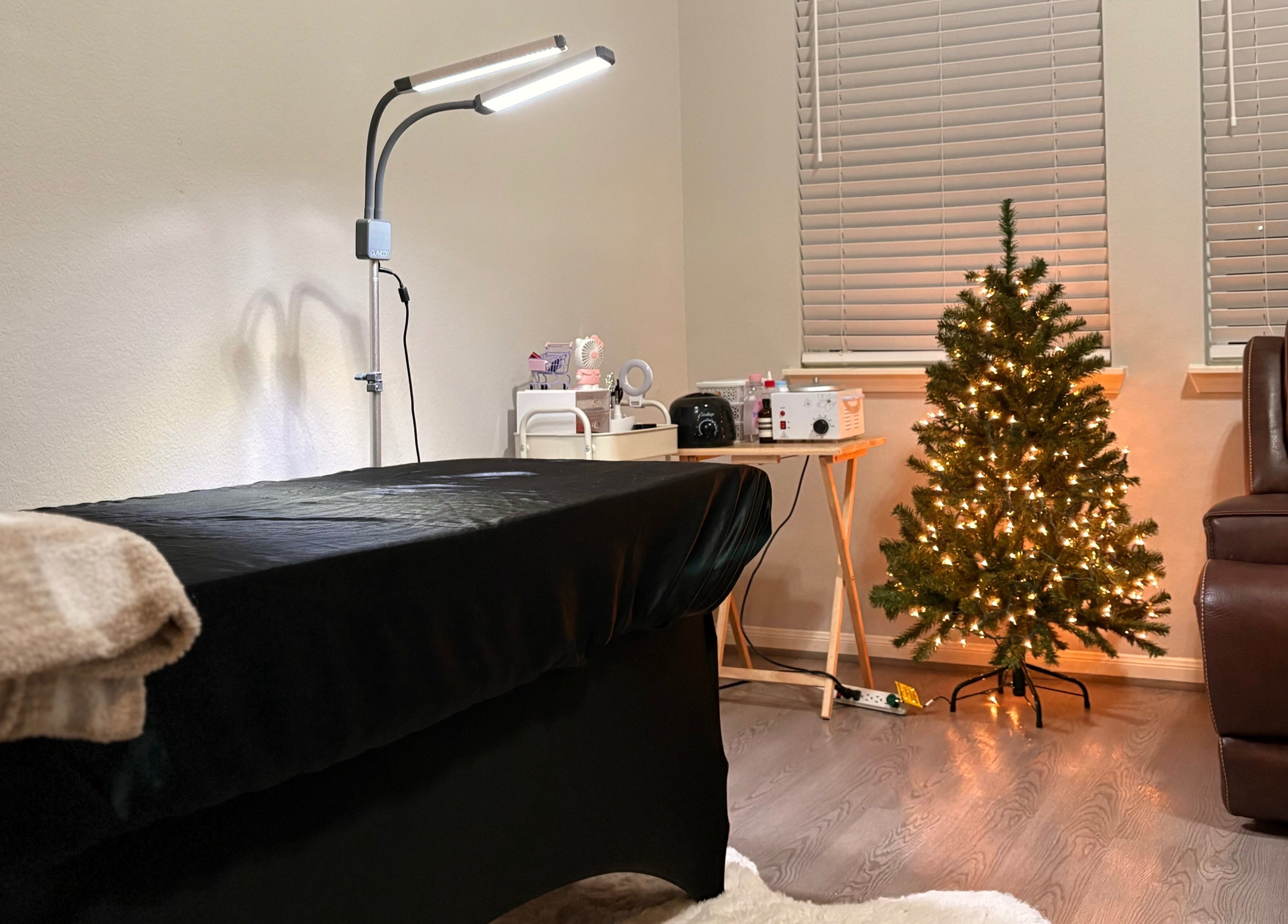 Elegance Studio treatment room with a massage table, festive decor, in Houston, Texas, US.