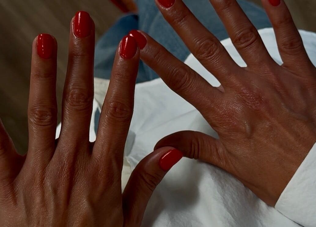 Mains avec vernis rouge à Chloé Buire Salon de Beauté & Académie, Saint Philipe, Québec, CA.