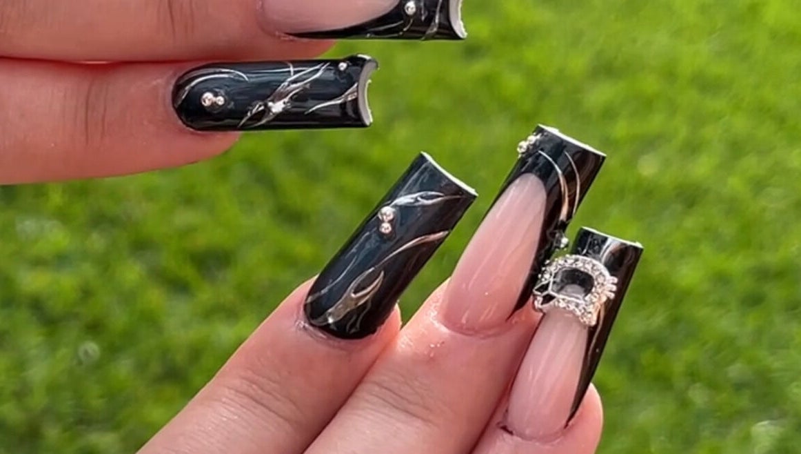 Stylish black and nude nail art with rhinestones at Demi.DidThem, Port St. Lucie, Florida, US.