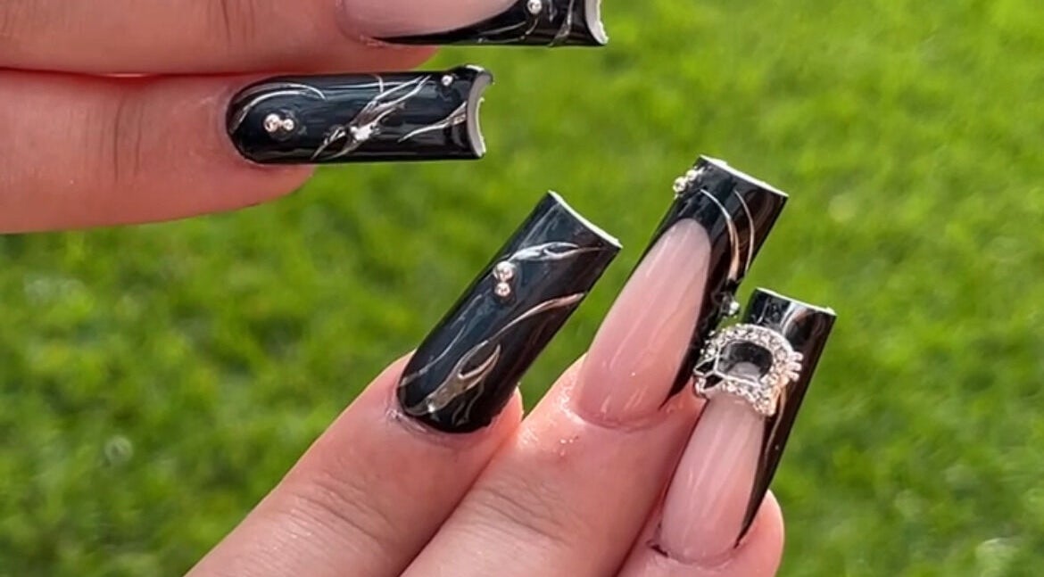 Stylish black and nude nail art with rhinestones at Demi.DidThem, Port St. Lucie, Florida, US.