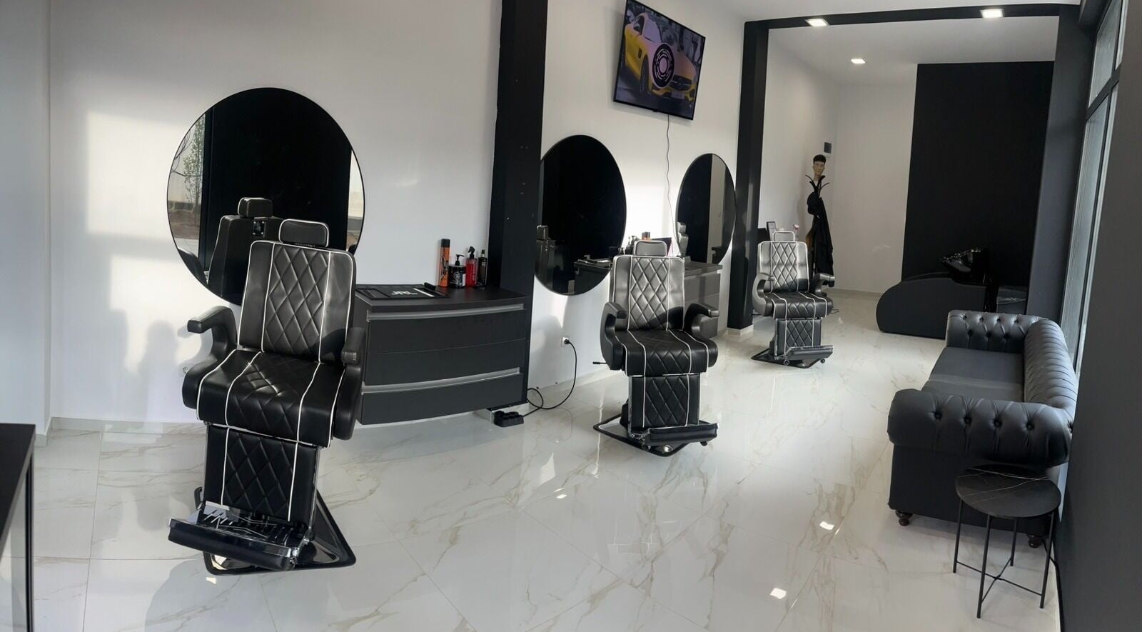 Modern interior of Fade Factory Barbershop in Botevgrad, Sofiyska Oblast, BG with sleek black chairs and decor.