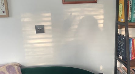 Cozy reading nook at Maple Leaf Massage Caerphilly, Caerphilly, Wales, GB, with books and soft lighting.