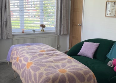 Inviting massage room at Maple Leaf Massage Caerphilly, featuring a floral blanket and bright decor in Caerphilly, Wales, GB.