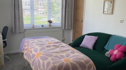 Inviting massage room at Maple Leaf Massage Caerphilly, featuring a floral blanket and bright decor in Caerphilly, Wales, GB.