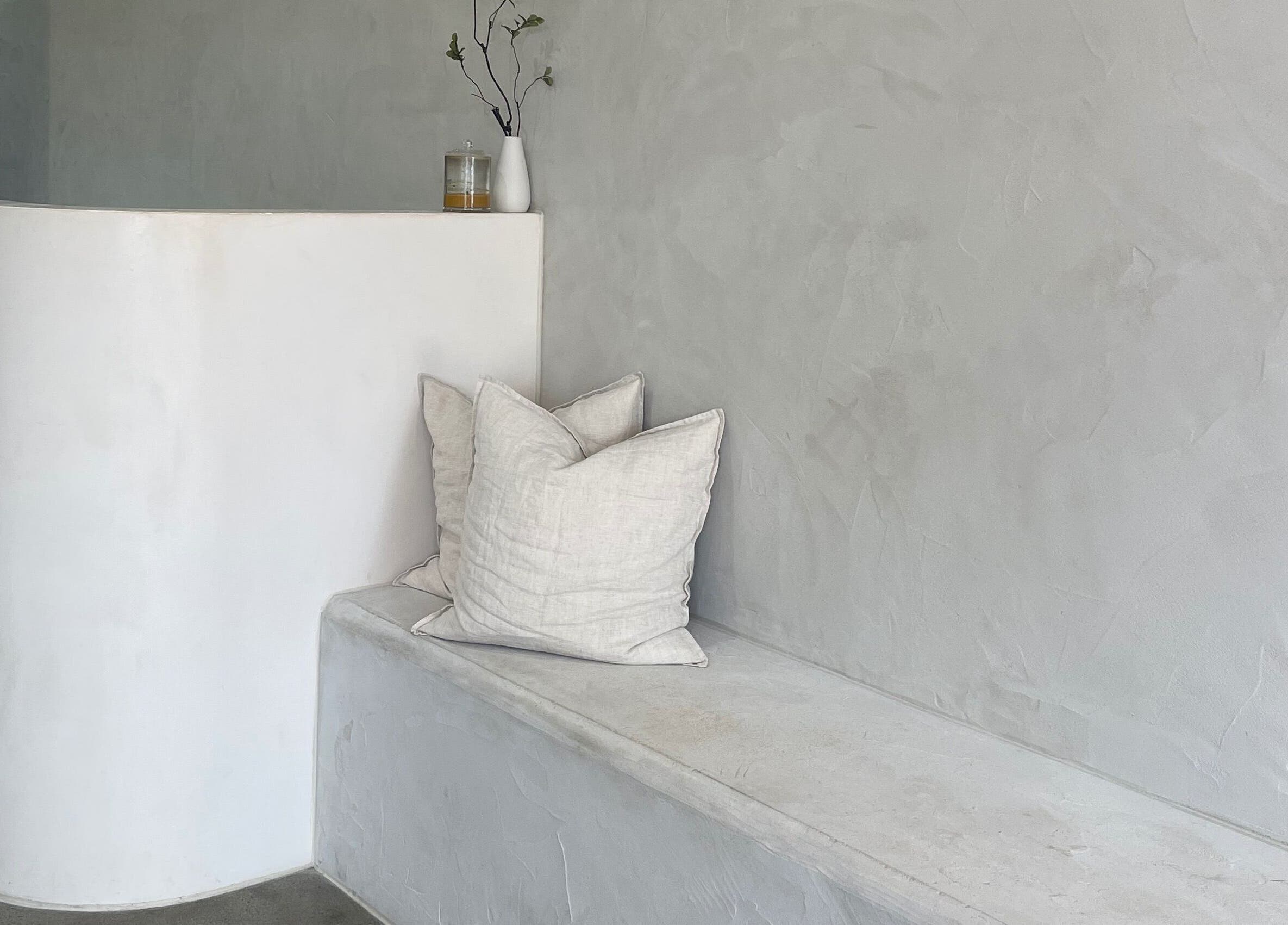 Elegant minimalistic seating at Bayse Hair Goldcoast, Nerang, Queensland, AU, featuring neutral tones and cushions.