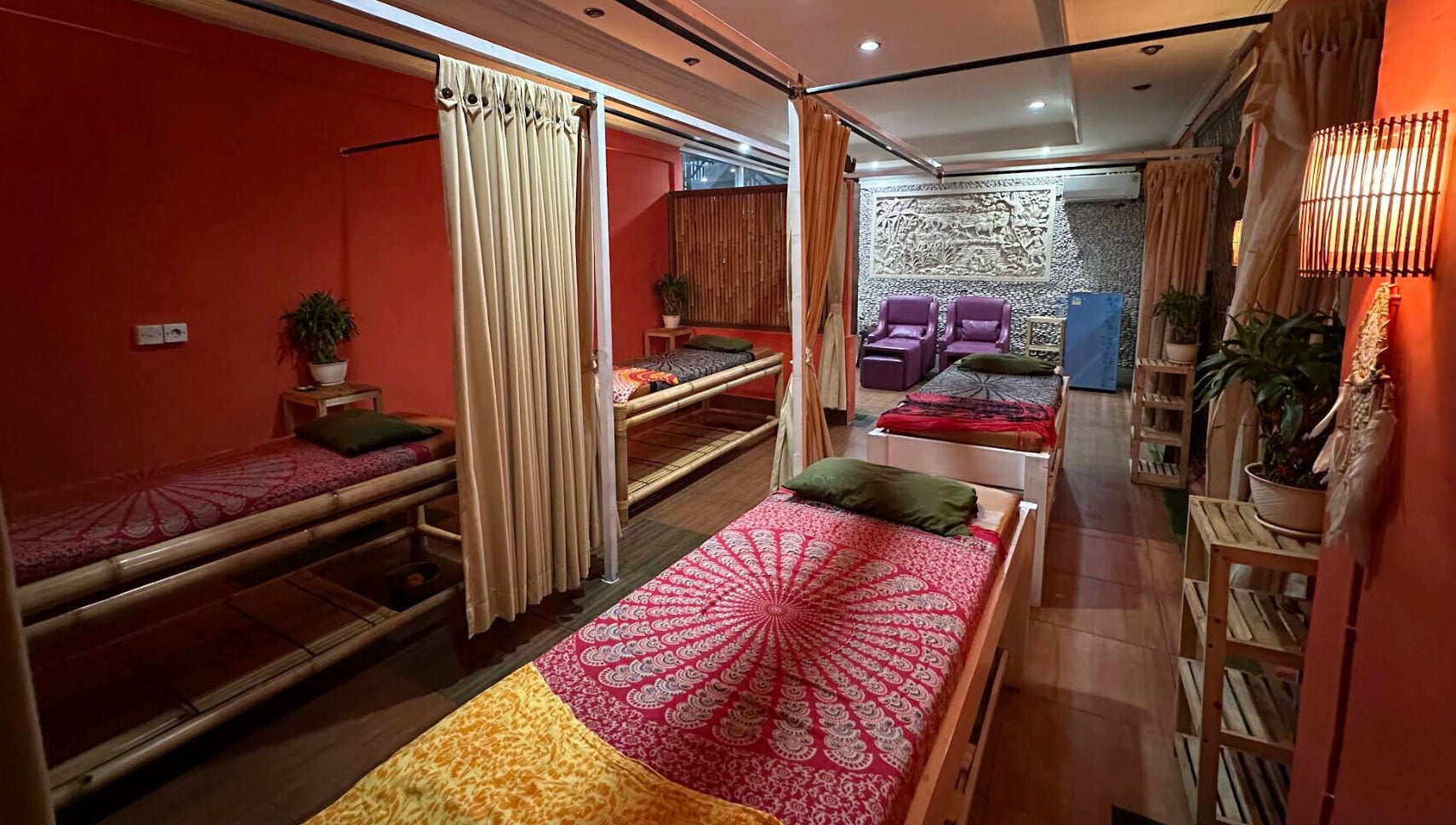 Relaxing massage room at Heals Spa and Barbershop, Bali, ID with warm lighting and cozy decor.