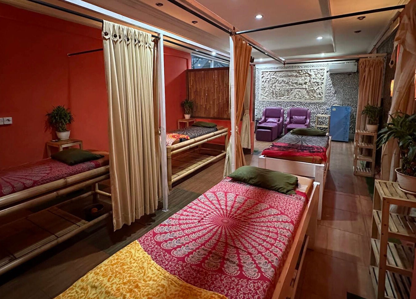 Relaxing massage room at Heals Spa and Barbershop, Bali, ID with warm lighting and cozy decor.