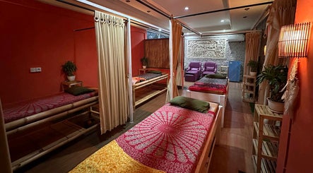 Relaxing massage room at Heals Spa and Barbershop, Bali, ID with warm lighting and cozy decor.