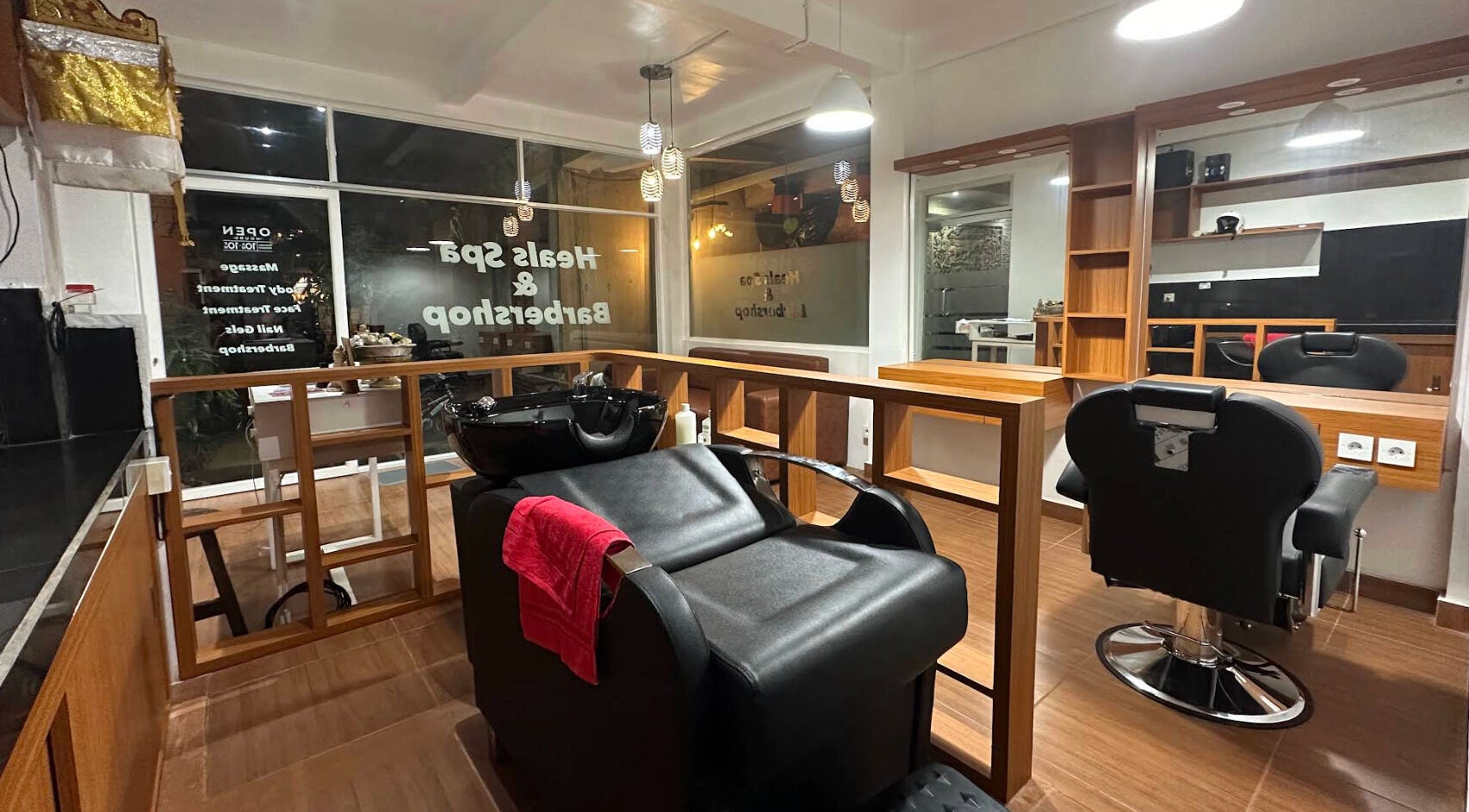 Modern barbershop interior at Heals Spa and Barbershop in Bali, Bali, ID with sleek design and elegant lighting.