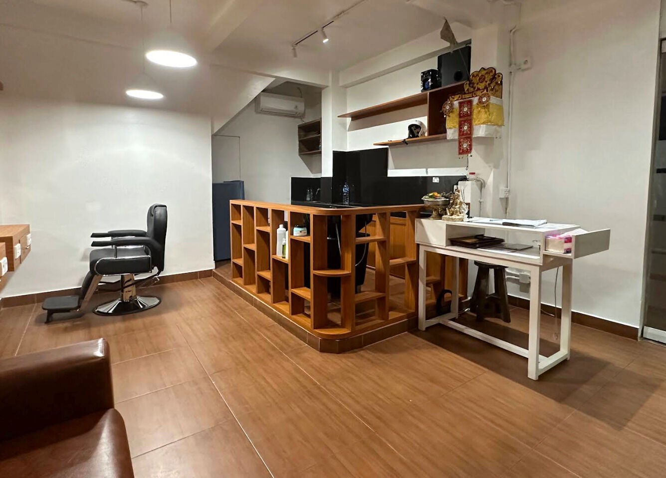 Modern barbershop interior at Heals Spa and Barbershop, Bali, Bali, ID with sleek chair and wooden decor.