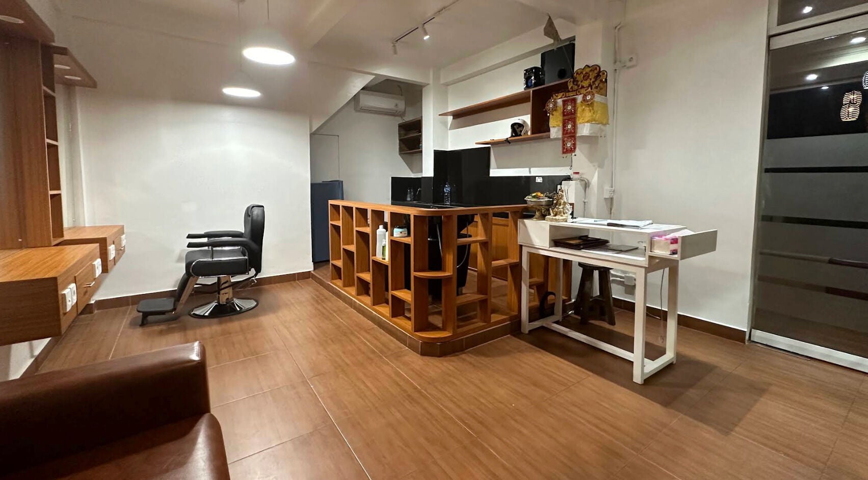 Modern barbershop interior at Heals Spa and Barbershop, Bali, Bali, ID with sleek chair and wooden decor.
