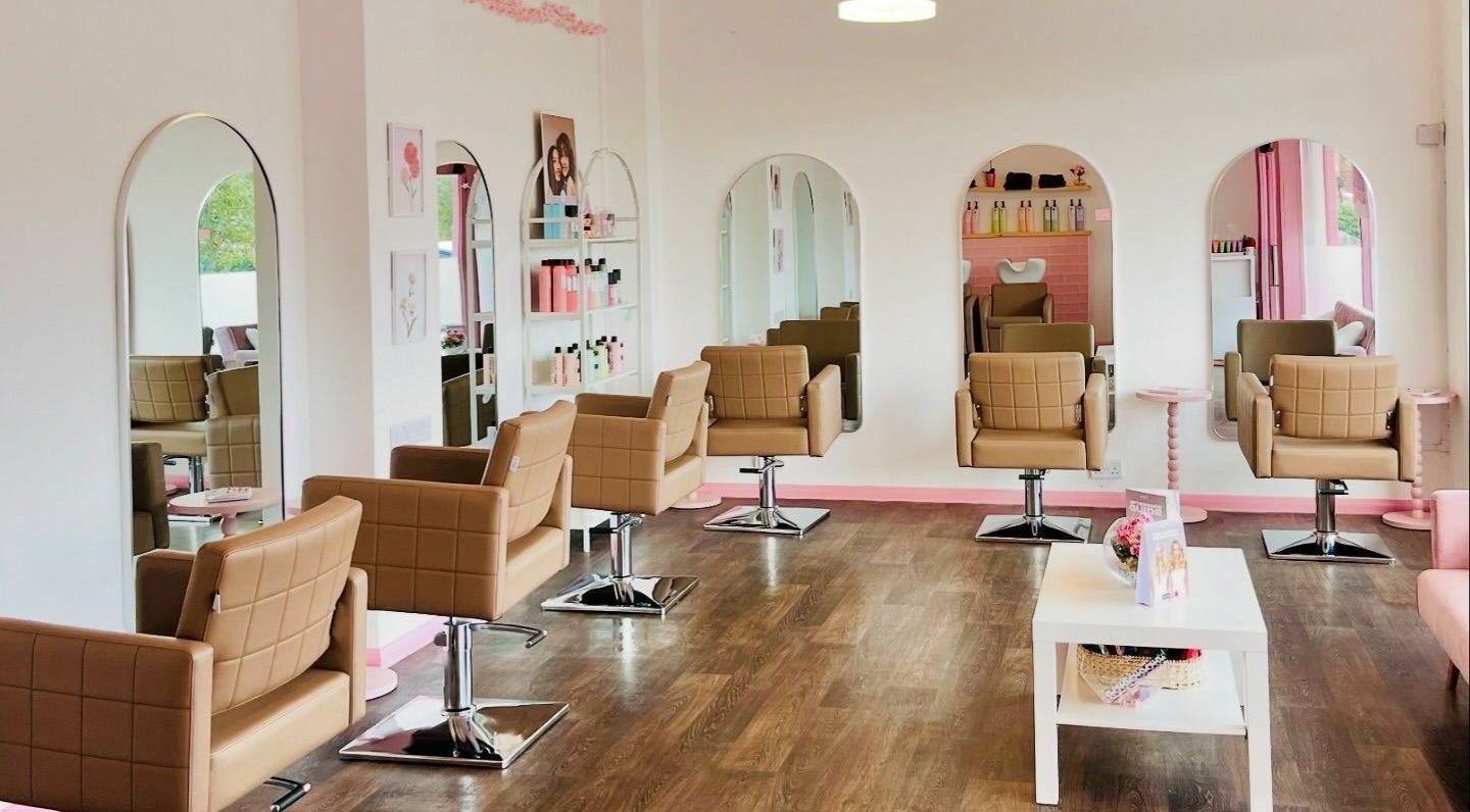 Modern interior of The Strawberry Salon, Derby, England, GB with stylish chairs and large mirrors.