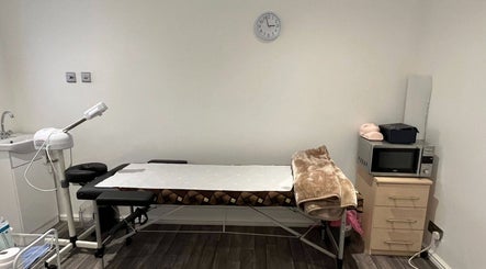 Calming treatment room at Mist Beauty in Southend-on-Sea, England with massage table and amenities.