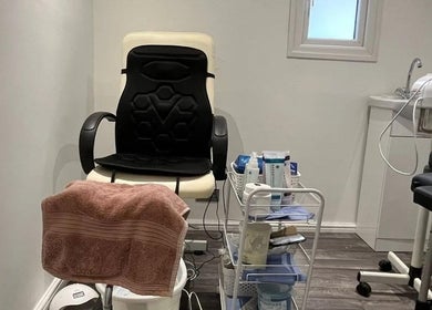 Cozy treatment room at Mist Beauty, Southend-on-sea, England, GB featuring a massage chair and skincare products.