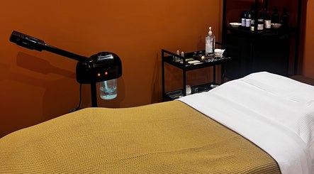Relaxing treatment room at Skin & Dosha South Bank Studio, London, England, GB, featuring massage table and skincare tools.