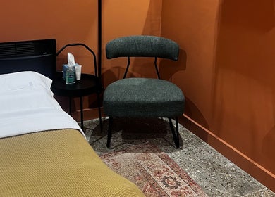 Cozy therapy room at Skin & Dosha South Bank Studio, London, England, GB with a comfy chair and treatment table.