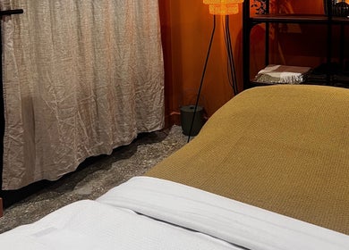 Relaxing massage room at Skin & Dosha South Bank Studio, London, England, GB, with warm lighting and soft textiles.