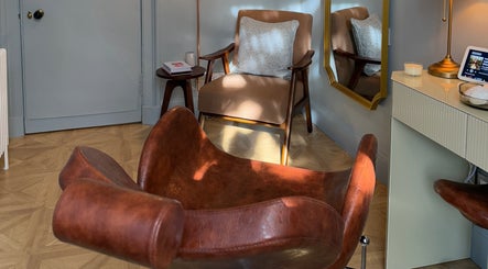Cozy seating area at Peaches & Pearls Studio, Dundee, Scotland, GB with brown chairs and ambient lighting.