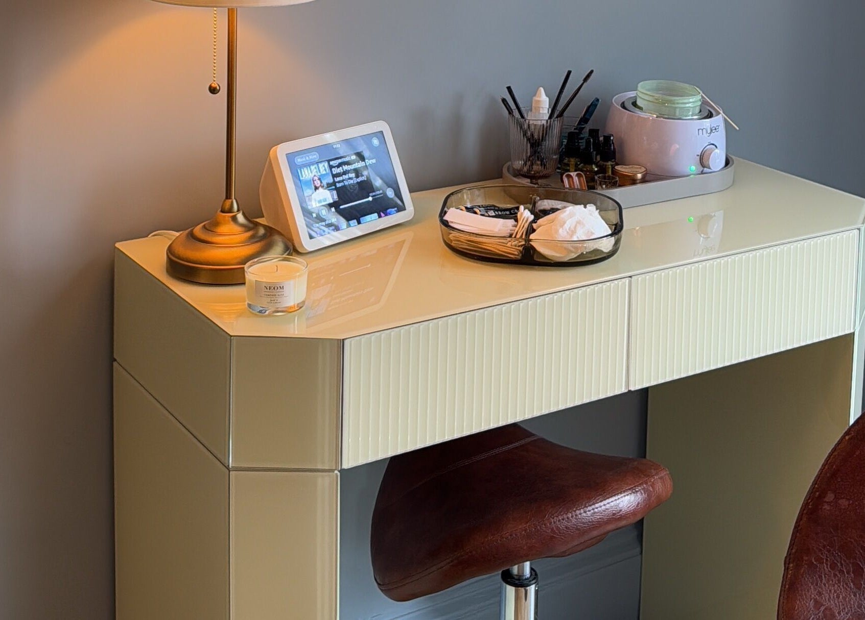 Modern treatment setup at Peaches & Pearls Studio in Dundee, Scotland, GB featuring a chic table and stool.