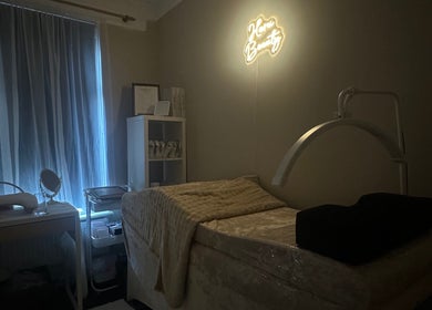 Tranquil room at Haru Beauty Lash extensions, Orrell, England, GB, with cozy bed and neon sign.