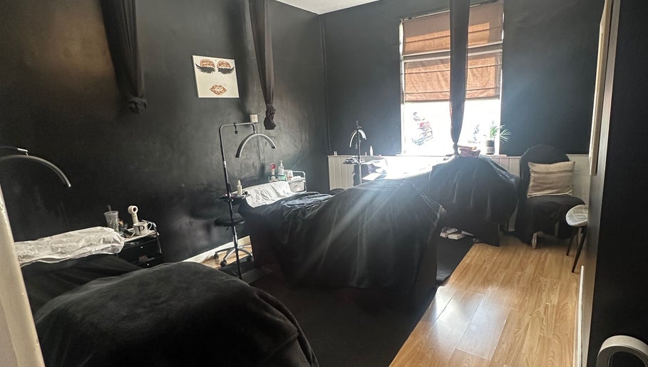 Cozy treatment room at Haru Beauty (Salon base), Wigan, England, GB, with black walls and wooden floor.