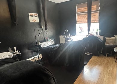 Cozy treatment room at Haru Beauty (Salon base), Wigan, England, GB, with black walls and wooden floor.