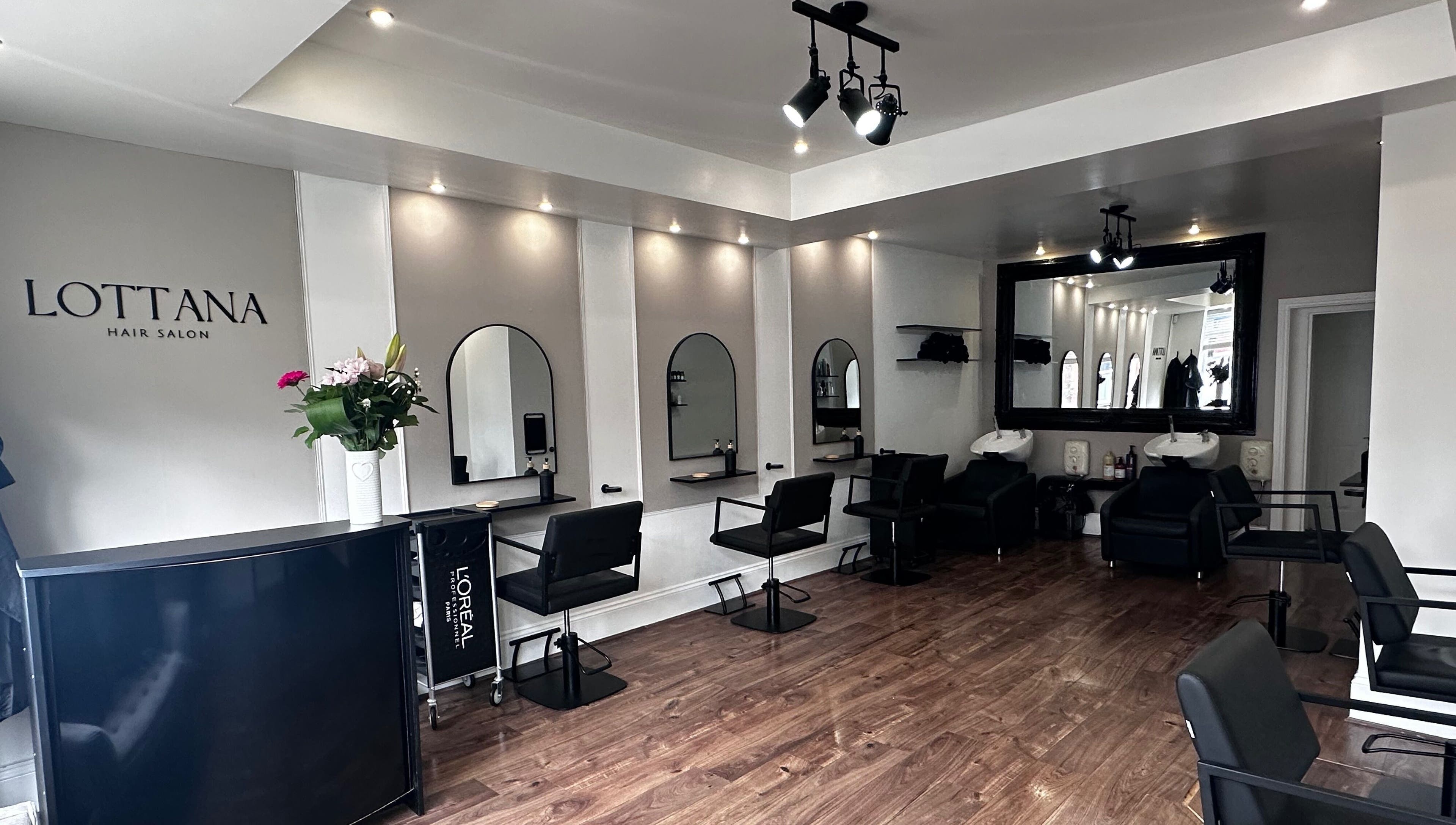 Modern interior of Lottana Hair Salon in Greenfield, England, GB, with stylish seating and mirrors.