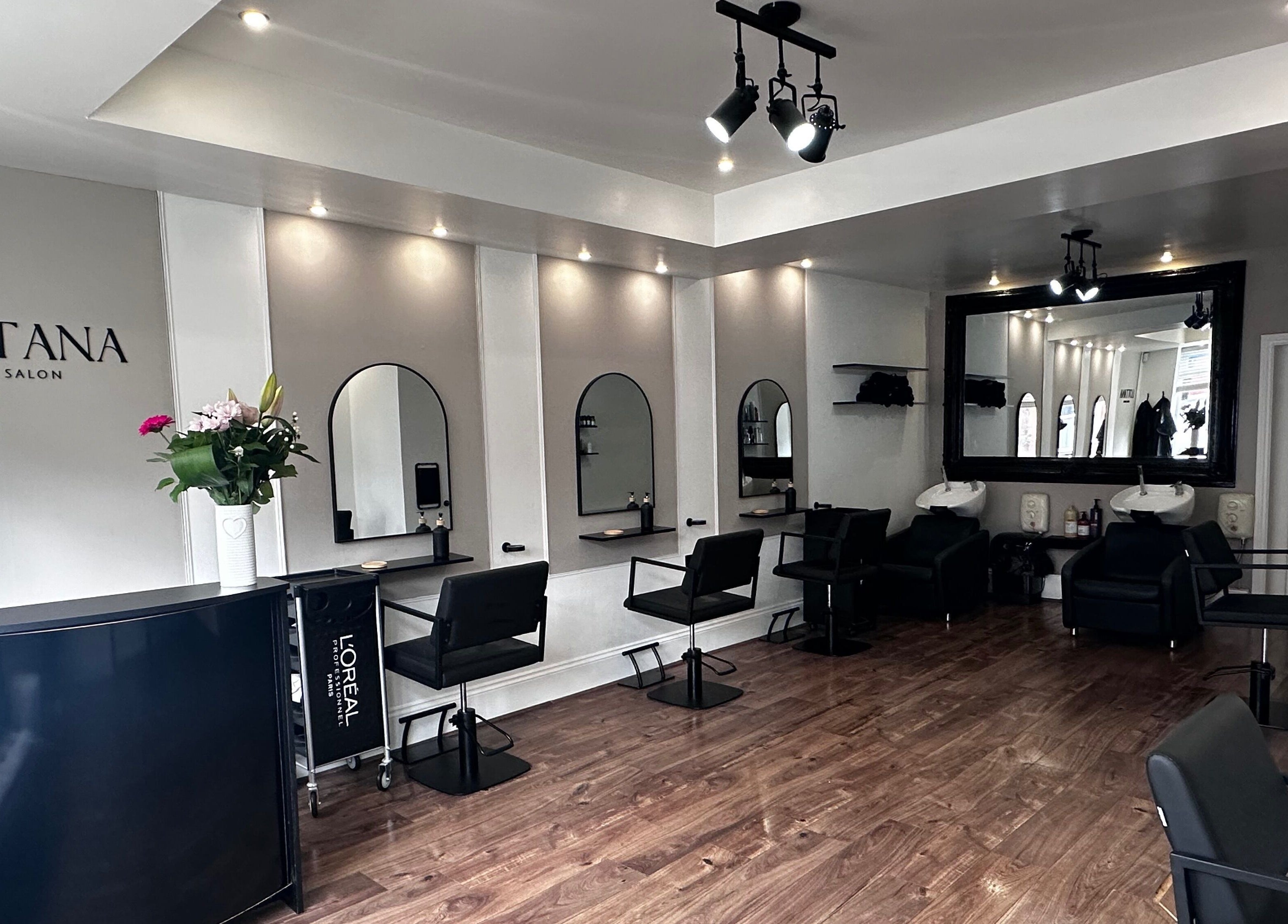 Modern interior of Lottana Hair Salon in Greenfield, England, GB, with stylish seating and mirrors.