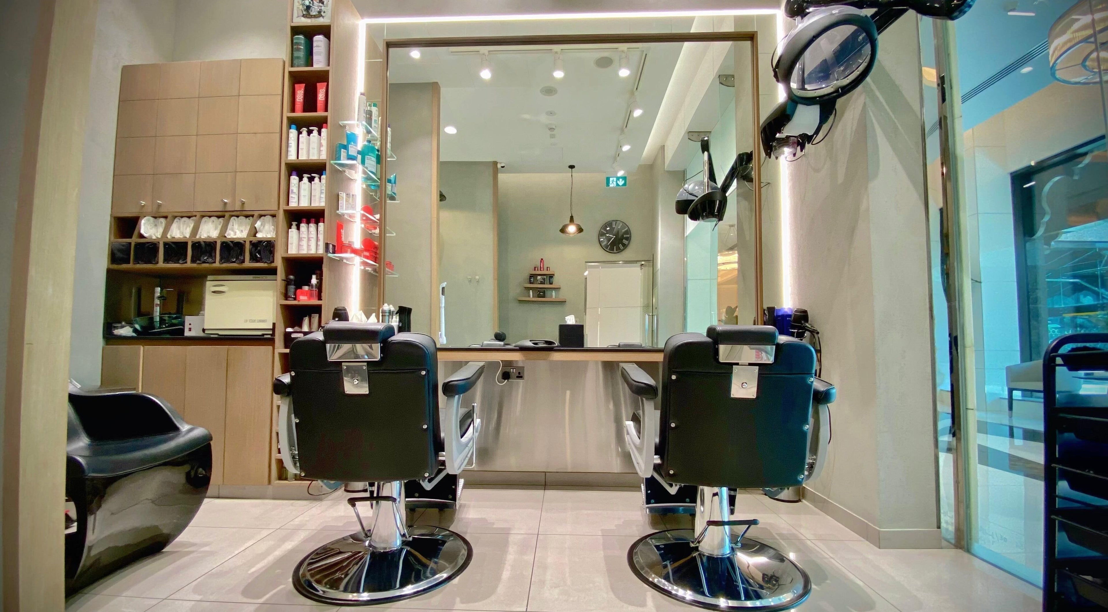 Modern interior of Barber 54 Gents Saloon in Dubai, Dubai, AE, featuring stylish black barber chairs and sleek design.