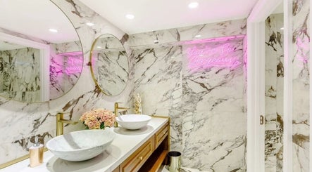 Luxurious marble bathroom at Anna’s Hair and Beauty, London, England, GB, featuring elegant decor.