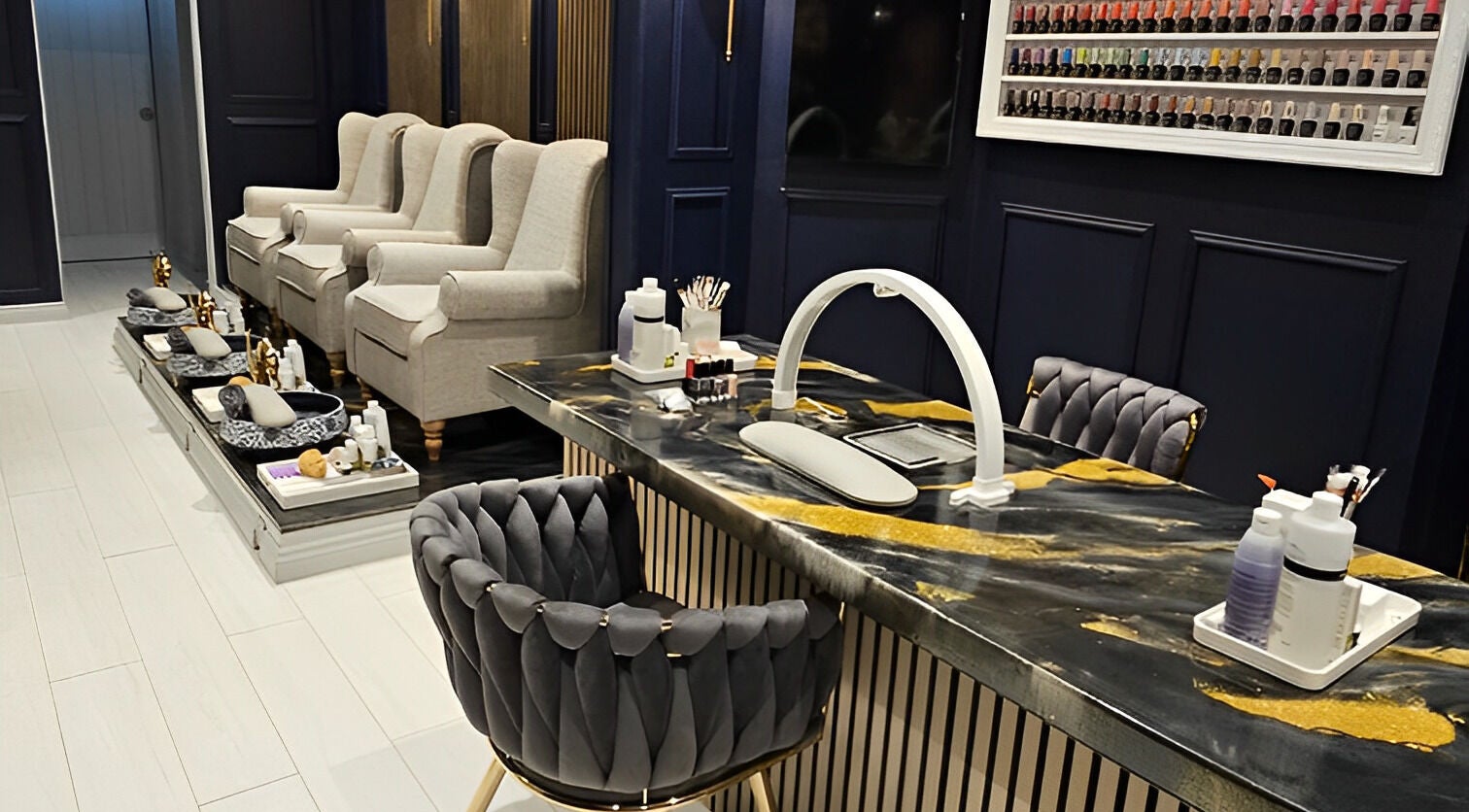 Elegant pedicure area at Sanya SPA, New Malden, England, GB with plush chairs and nail polish display.