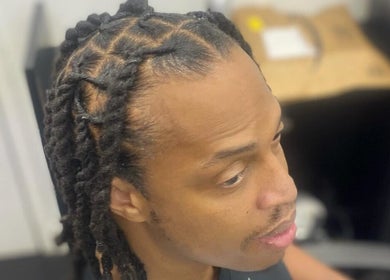 Intricate dreadlocks style at Dreads by Day, Decatur, Georgia, US, highlighting clean and neat twists.