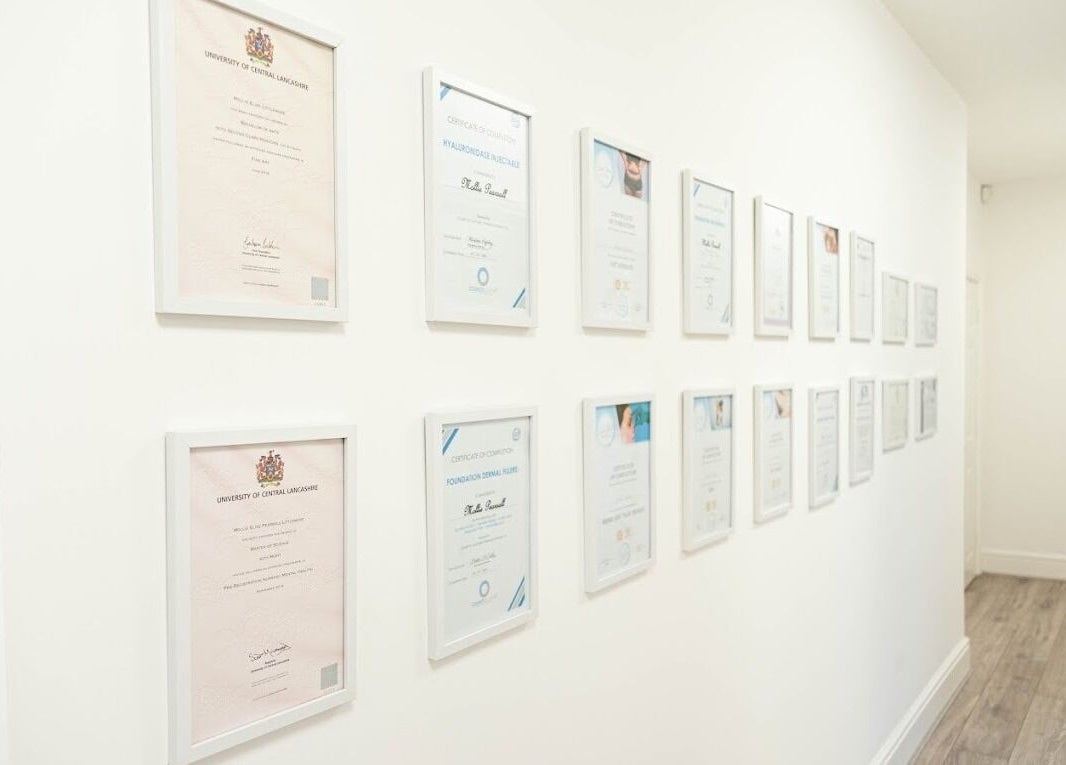 Wall of certificates at Mollie Elise Aesthetics, Chorley, England, GB, showcasing professional expertise.