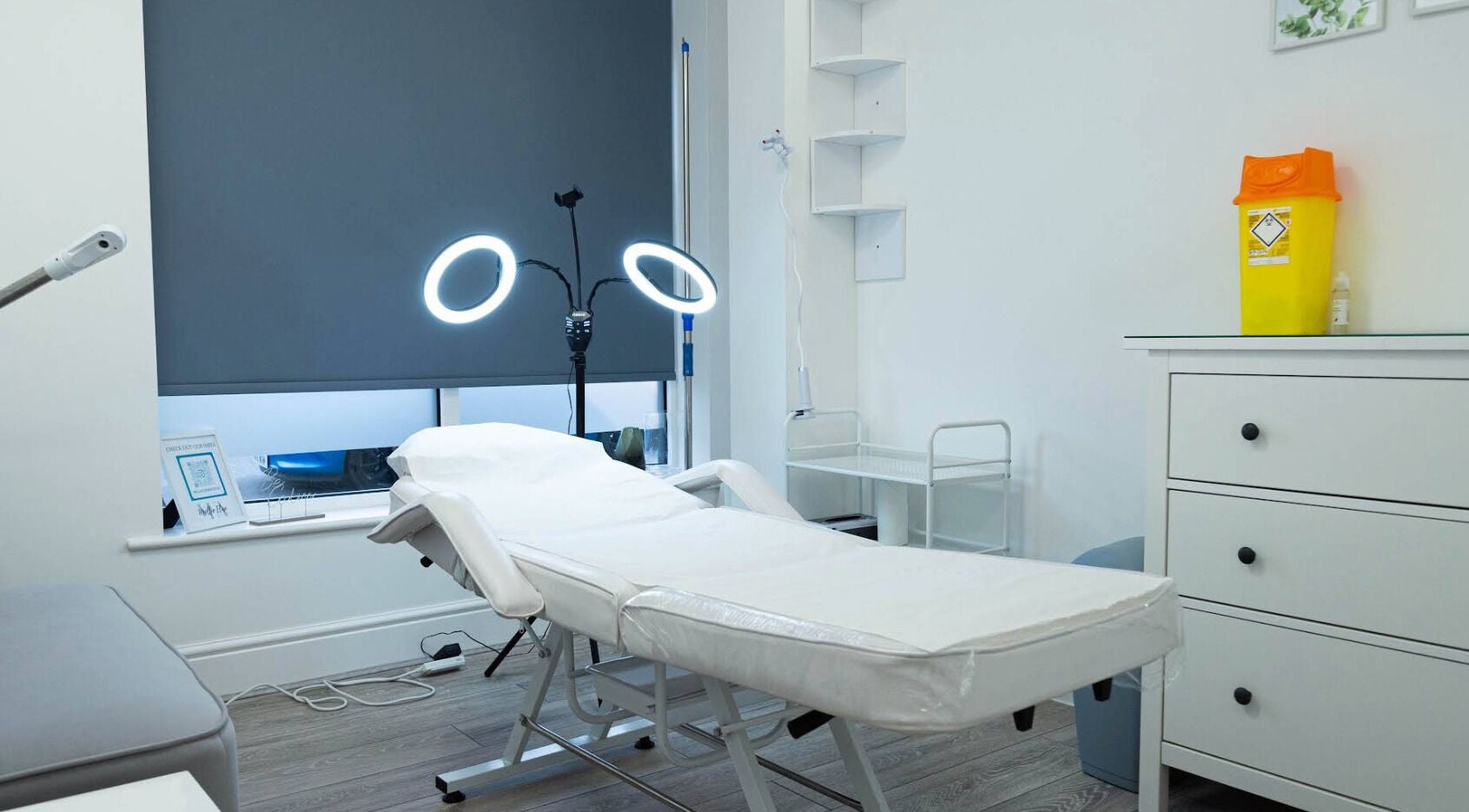 Treatment room at Mollie Elise Aesthetics in Chorley, England, GB featuring a bed and ring lights.