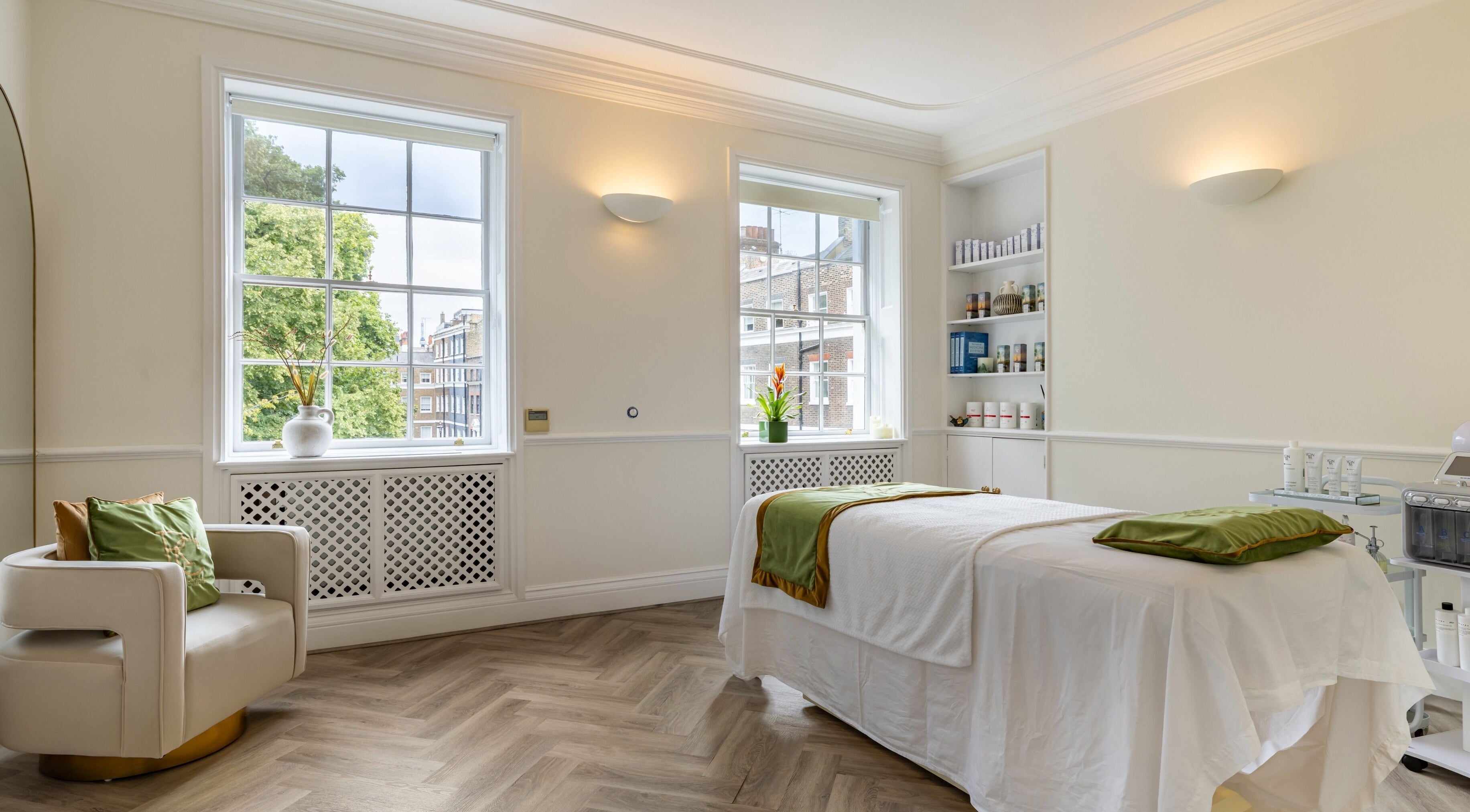Bright therapy room at Rose Beauty Clinic, London, England, GB, with massage bed and soft lighting.