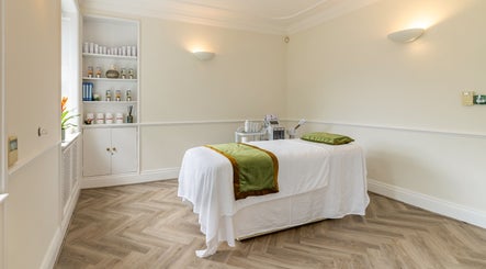 Calming treatment room at Rose Beauty Clinic in London, England, GB with a neatly arranged massage table.
