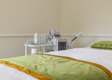 Elegant spa room at Rose Beauty Clinic, London, England, GB, featuring a treatment bed and skincare equipment.