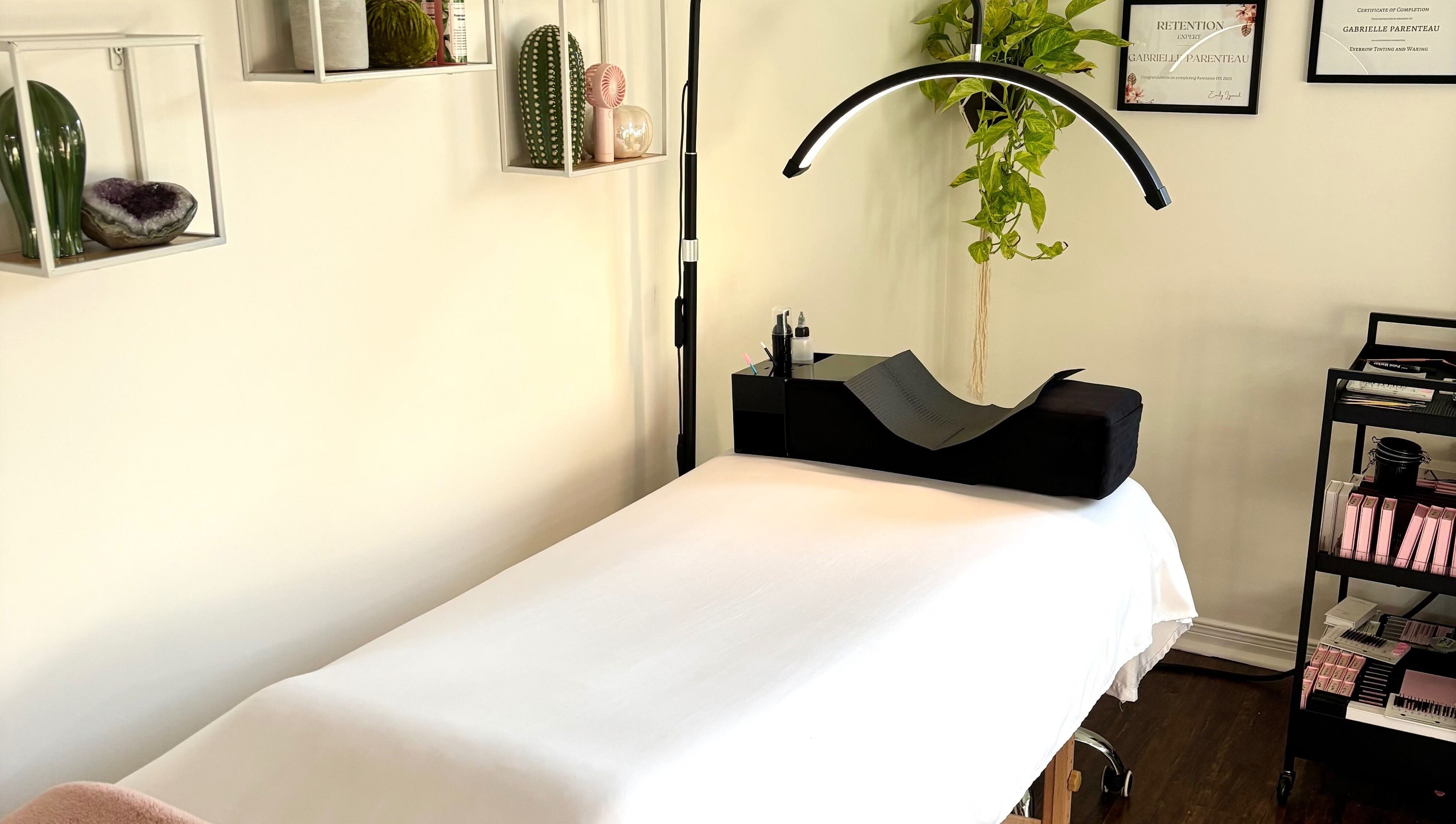Lunaria Lash Loft treatment room in Barrie, Ontario, CA, featuring a cozy bed and organized beauty tools.