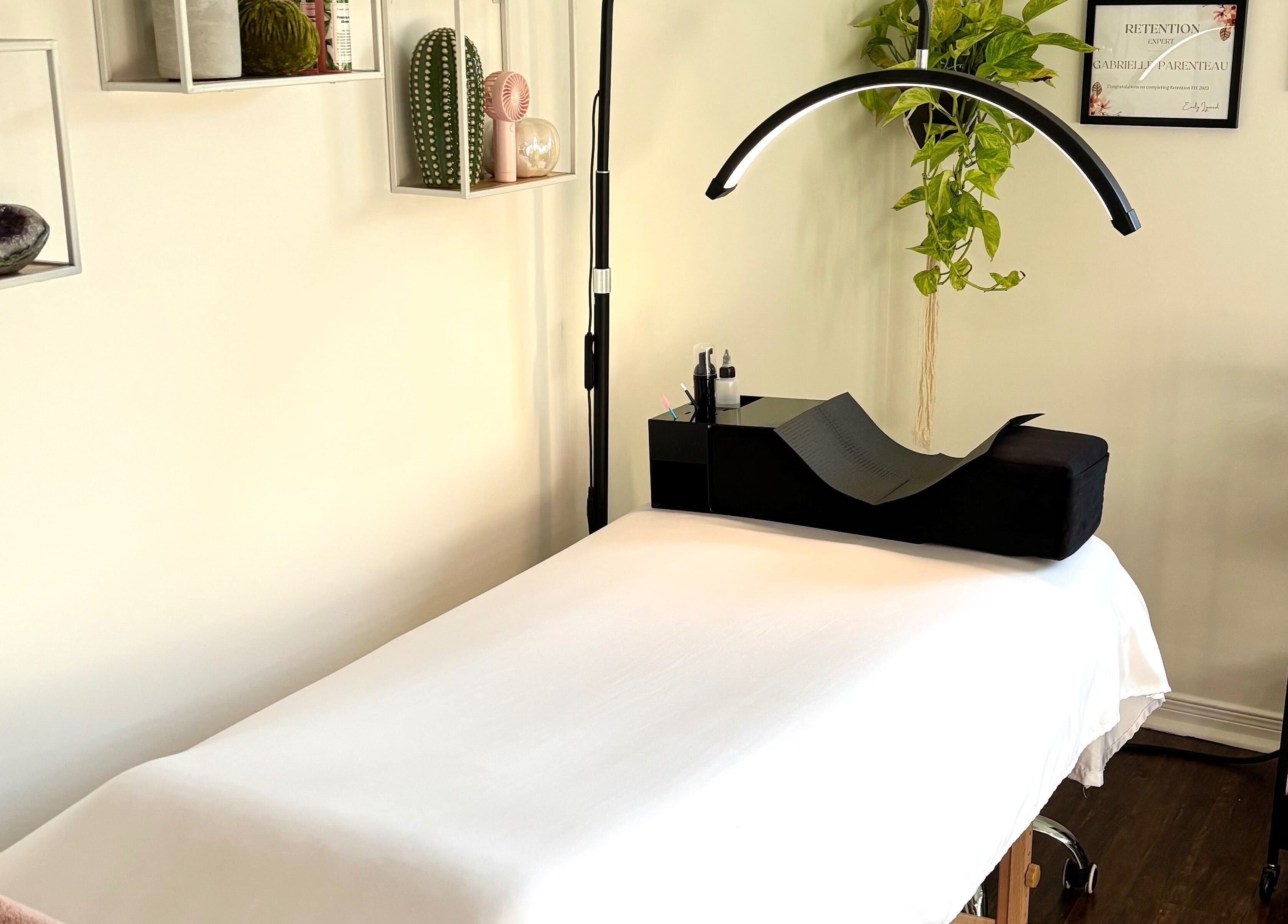 Lunaria Lash Loft treatment room in Barrie, Ontario, CA, featuring a cozy bed and organized beauty tools.